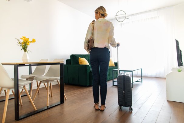 woman with suitcase in apartment