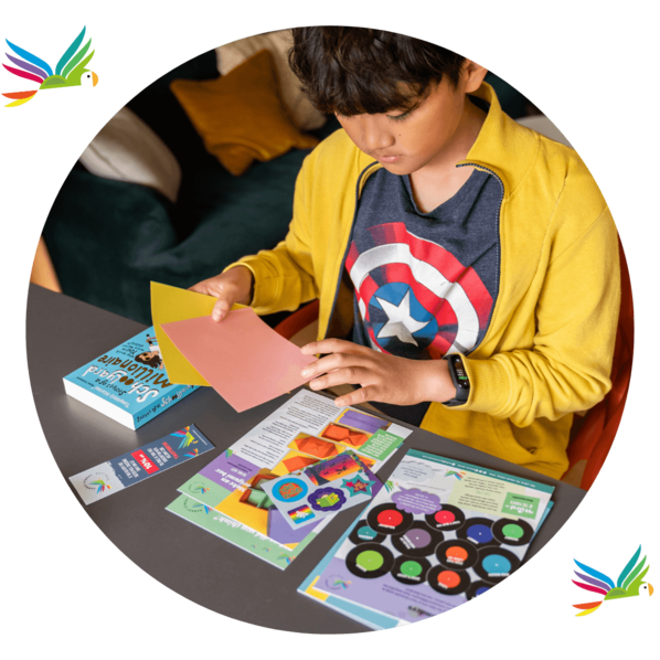 Boy looking through a subscription box including a chapter book and activity pack