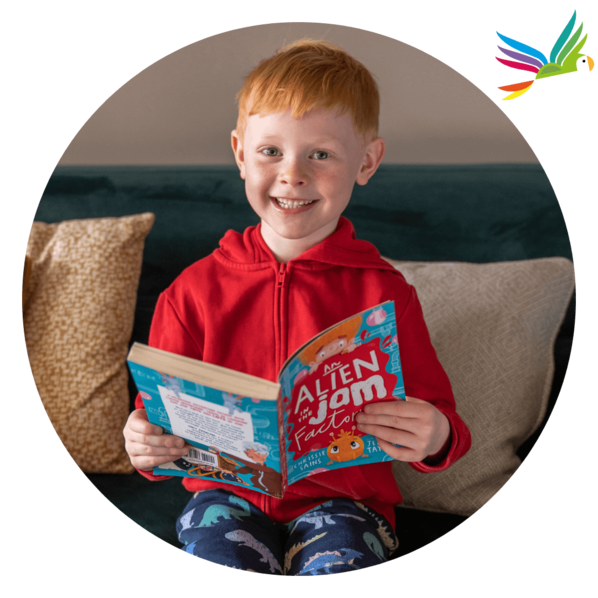 Smiling boy holding up a chapter book