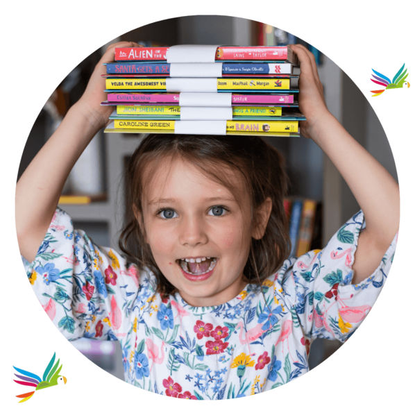 Smiling girl holding a pile of chapter book and activity pack bundles on her head