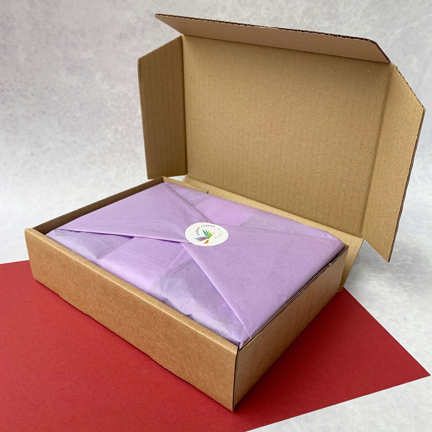 Wrapped gift set inside a recyclable cardboard mailing box