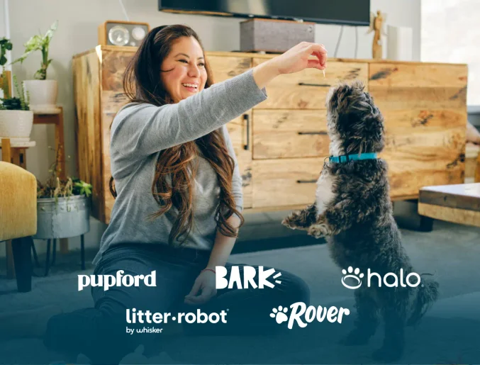 Photo of a woman playing with a dog with sponsors “pupford”, “bark”, “halo” “litter robot” and “rover” 