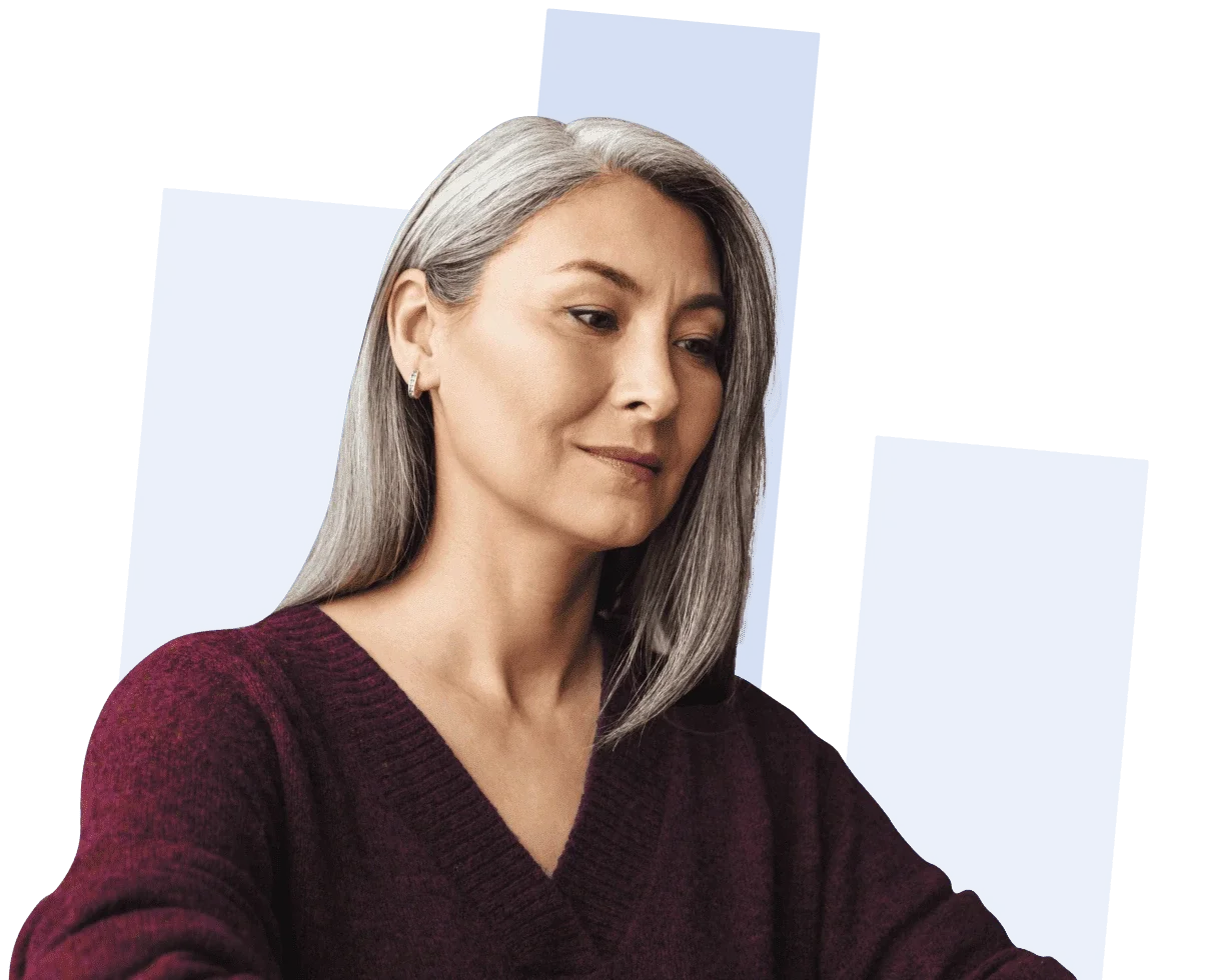 A woman with straight gray hair wearing a burgundy sweater looks slightly downward, with abstract blue rectangles in the background.