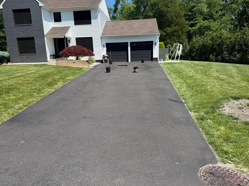 Wide residential driveway sealcoating before PureSeal sealcoating