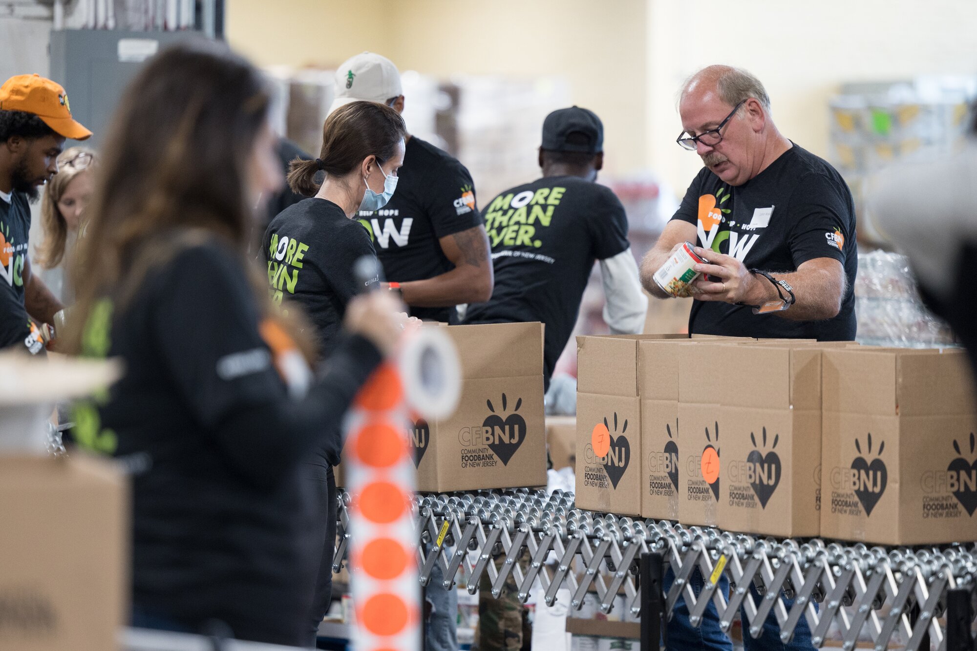 community foodbank of new jersey volunteers packing boxes