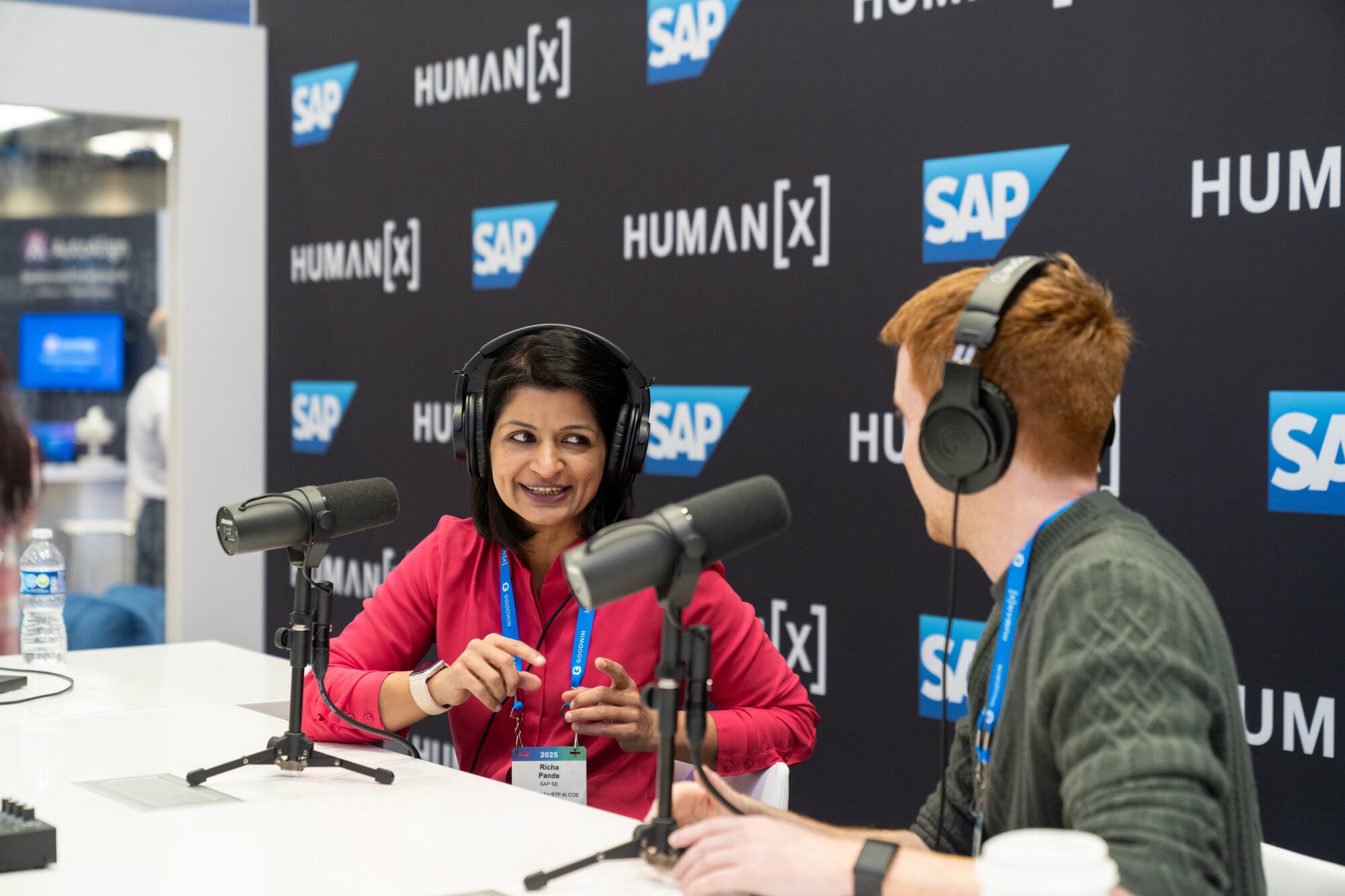Liz Claman films the claman countdown in front of the main stage at humanx 2025