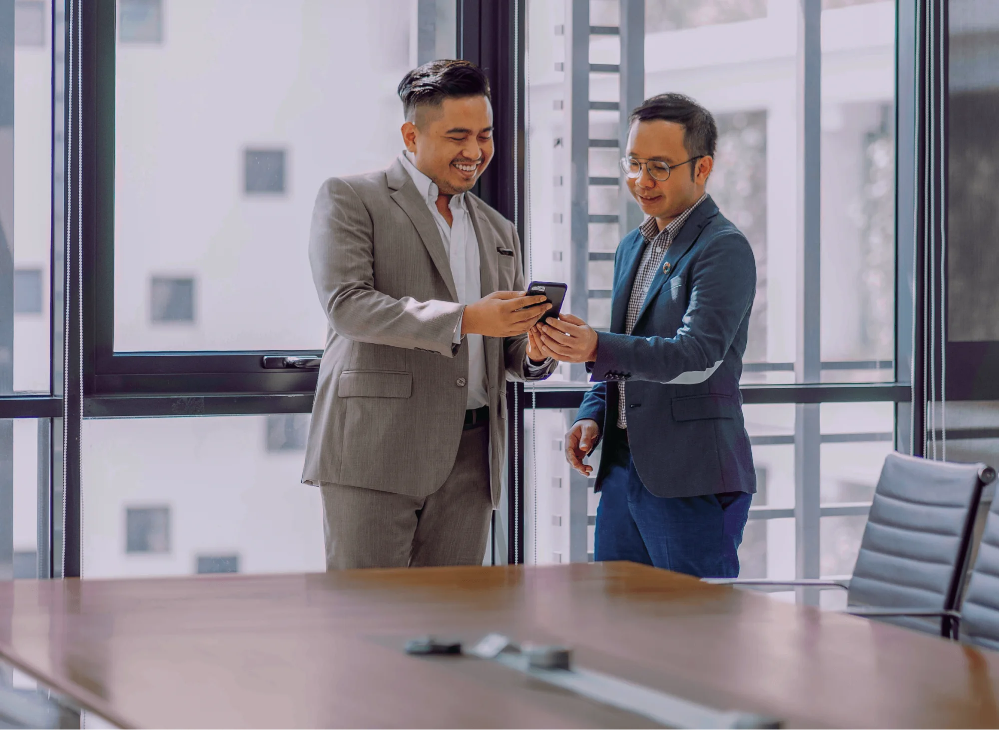 Two business men looking at a mobile phone