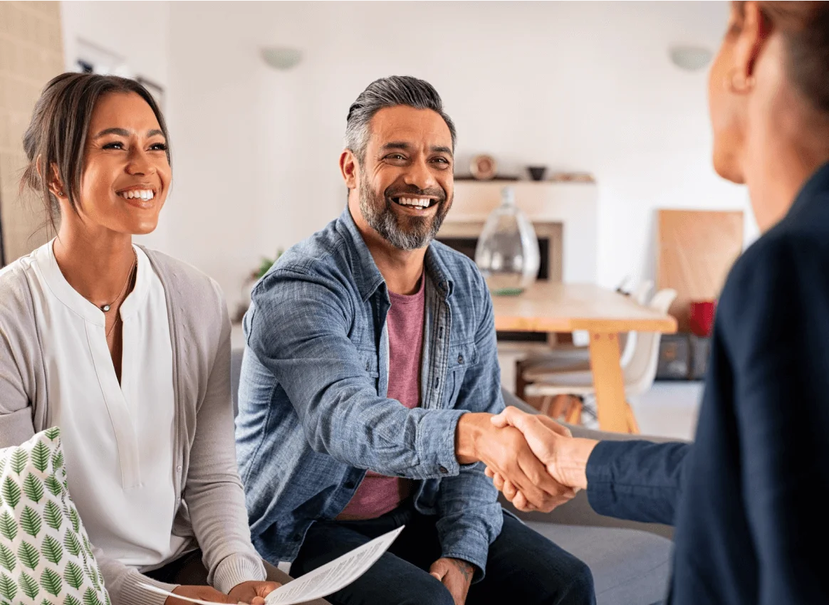 Couple in a meeting holding paperwork