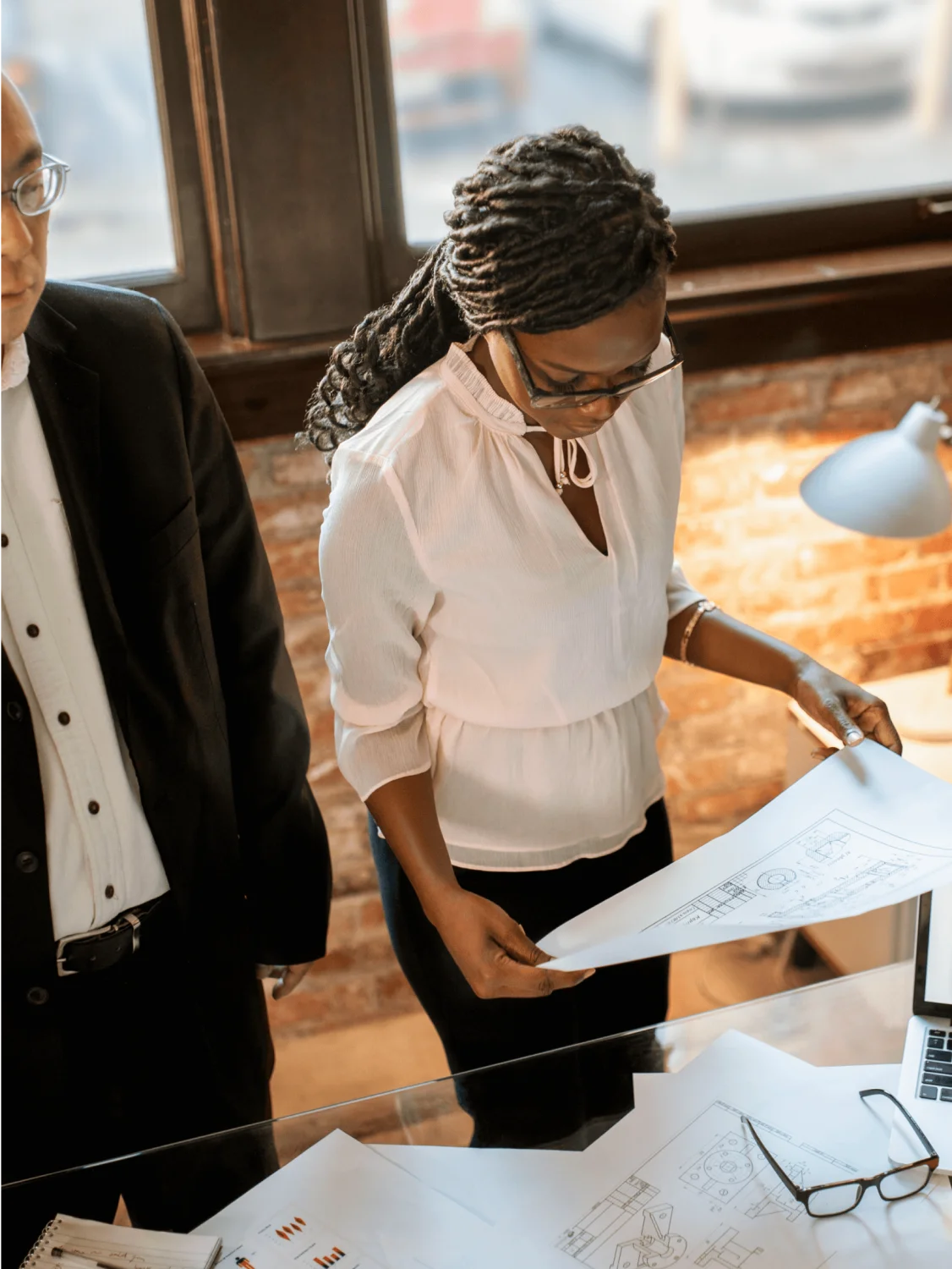 Business woman and man reviewing plans
