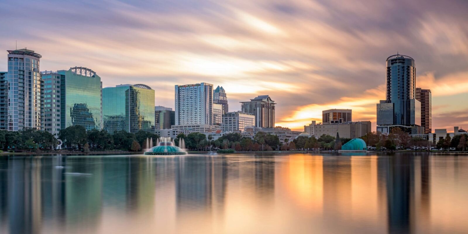 "City skyline, fountain, and water"