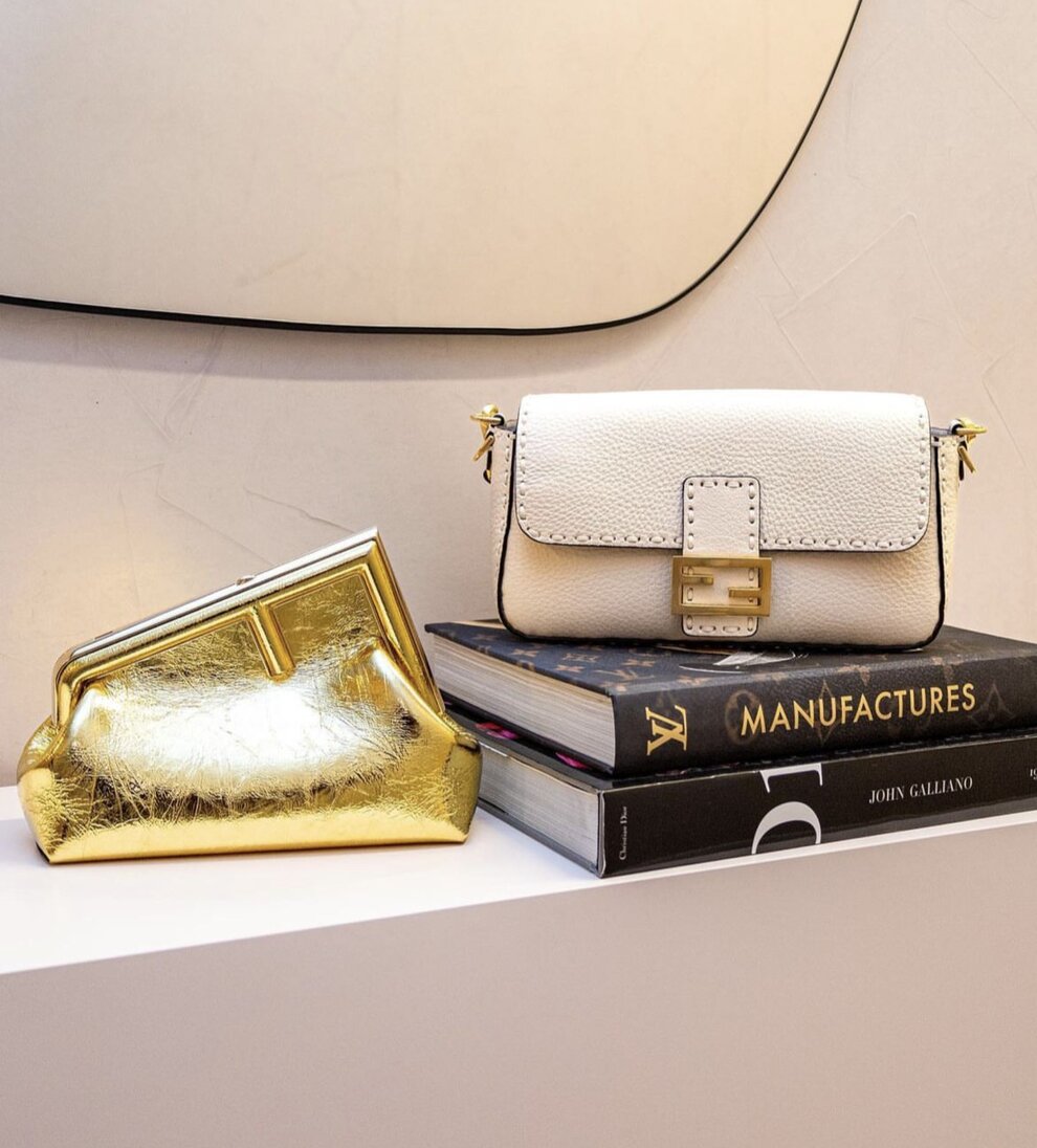 Two luxury handbags sitting on top of a table.