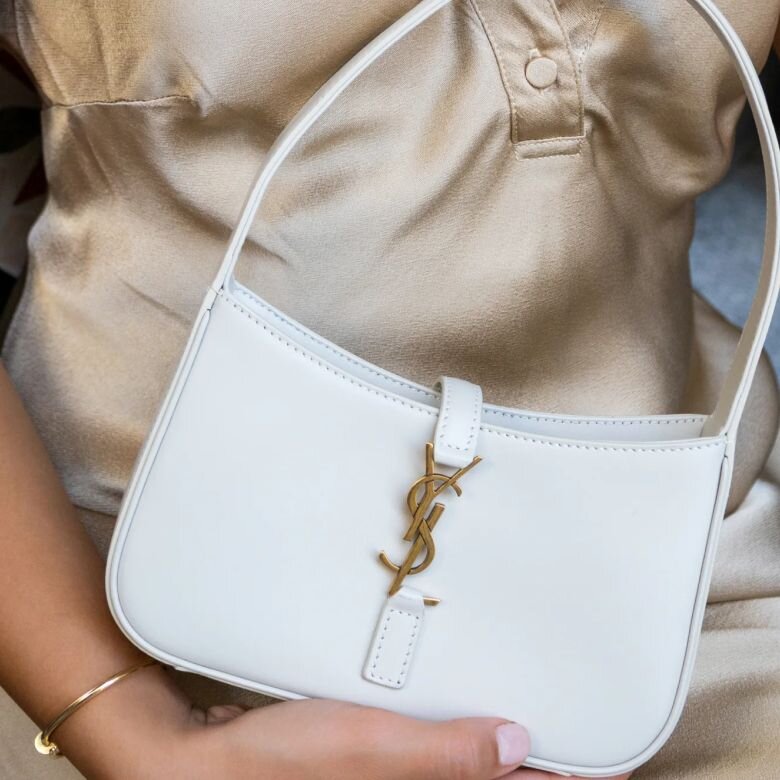 Image of women holding a bridal luxury handbag from Vivrelle.