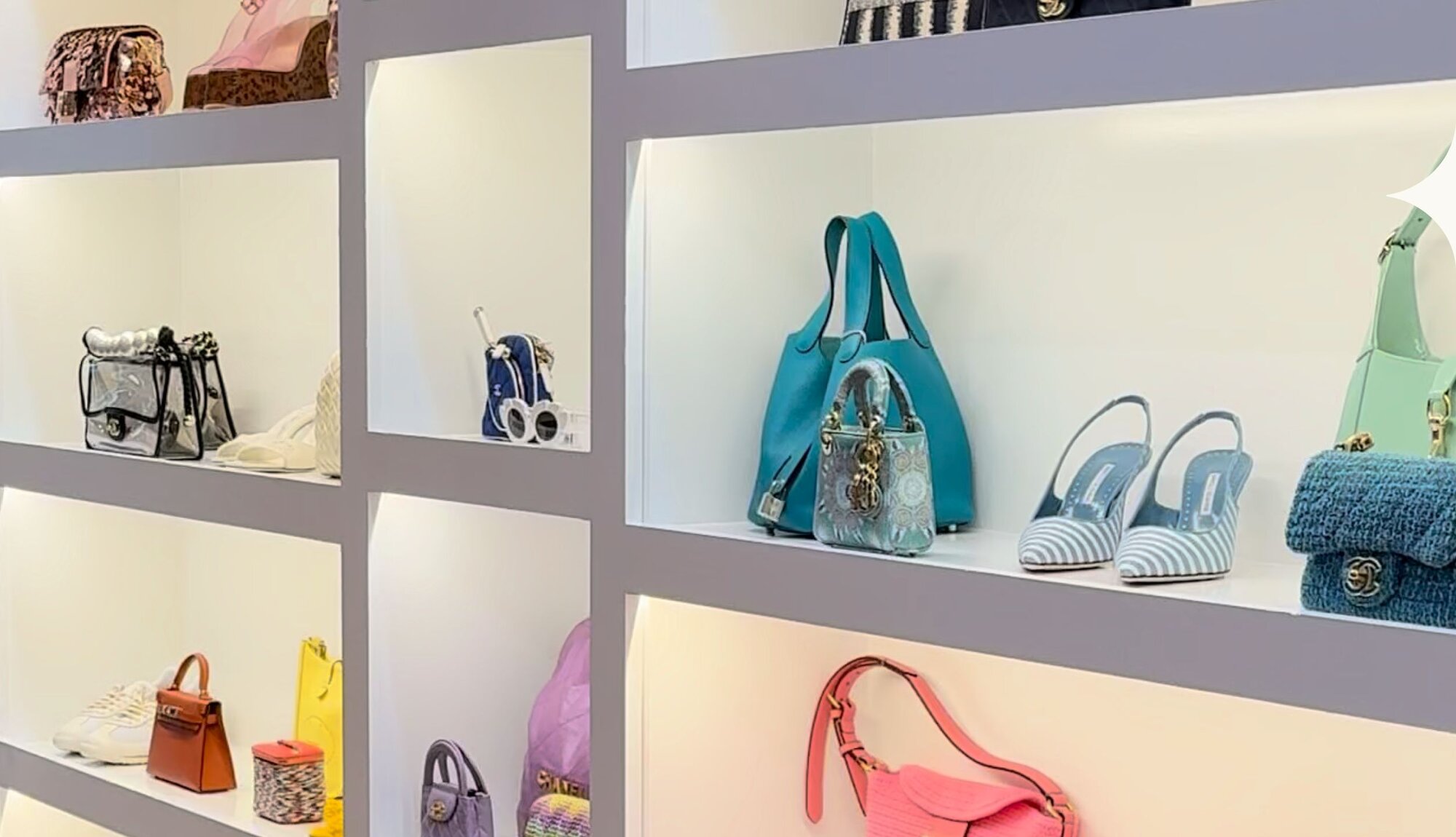 Image of women holding luxury handbags and wearing jewelry from Vivrelle.