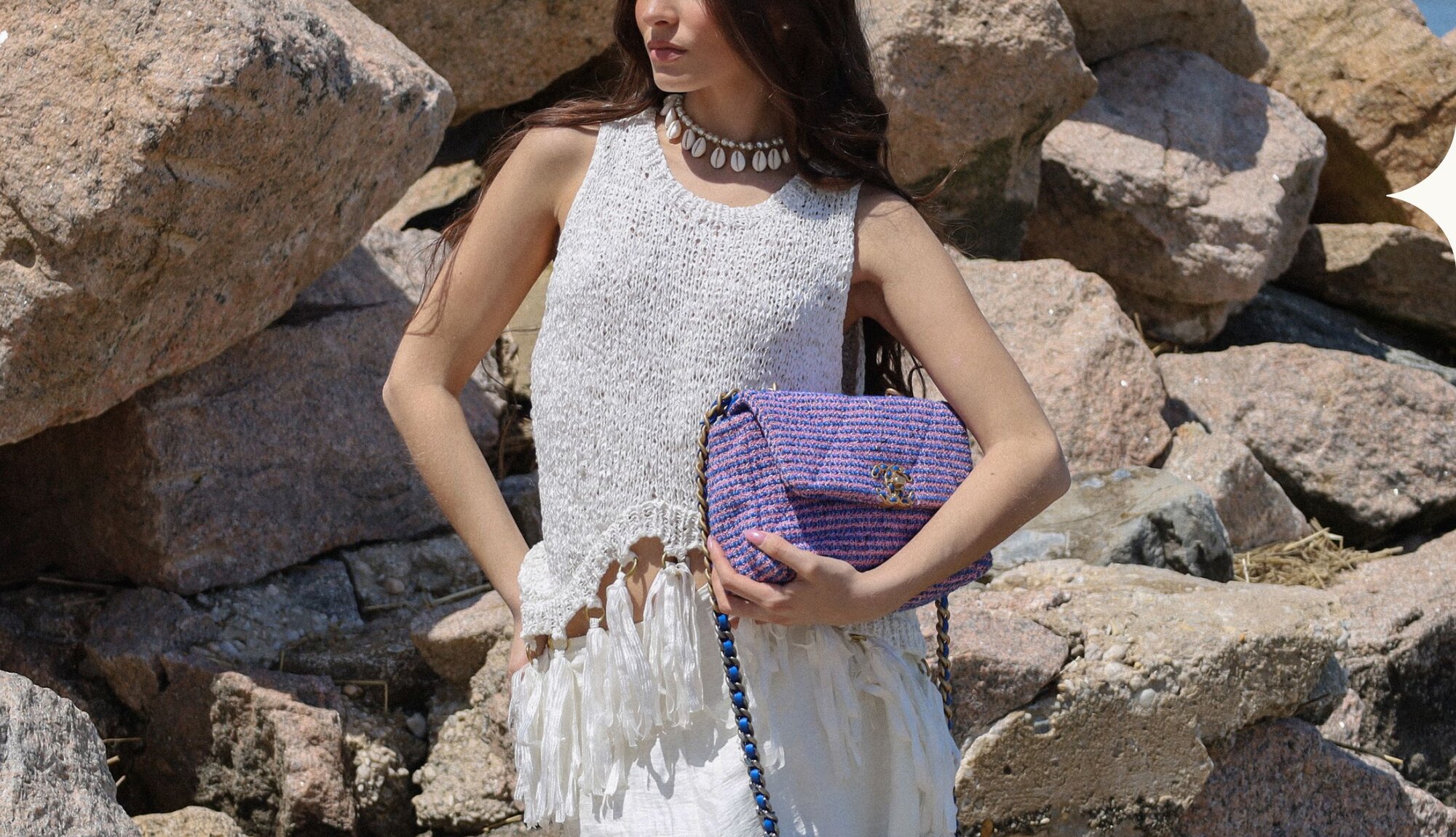 Image of a woman with a luxury handbag from Vivrelle.