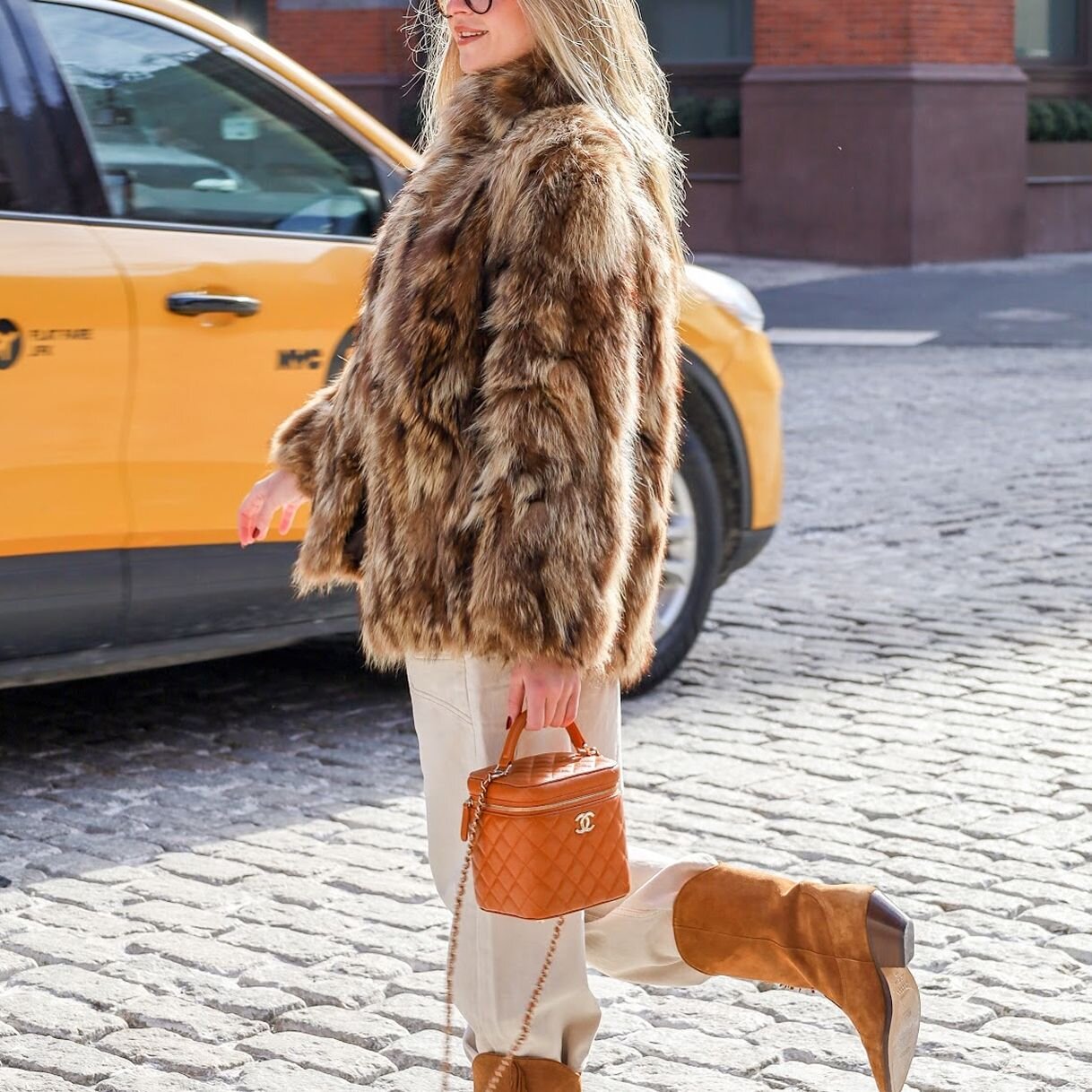 Woman carrying a luxury bag from Vivrelle in SoHo