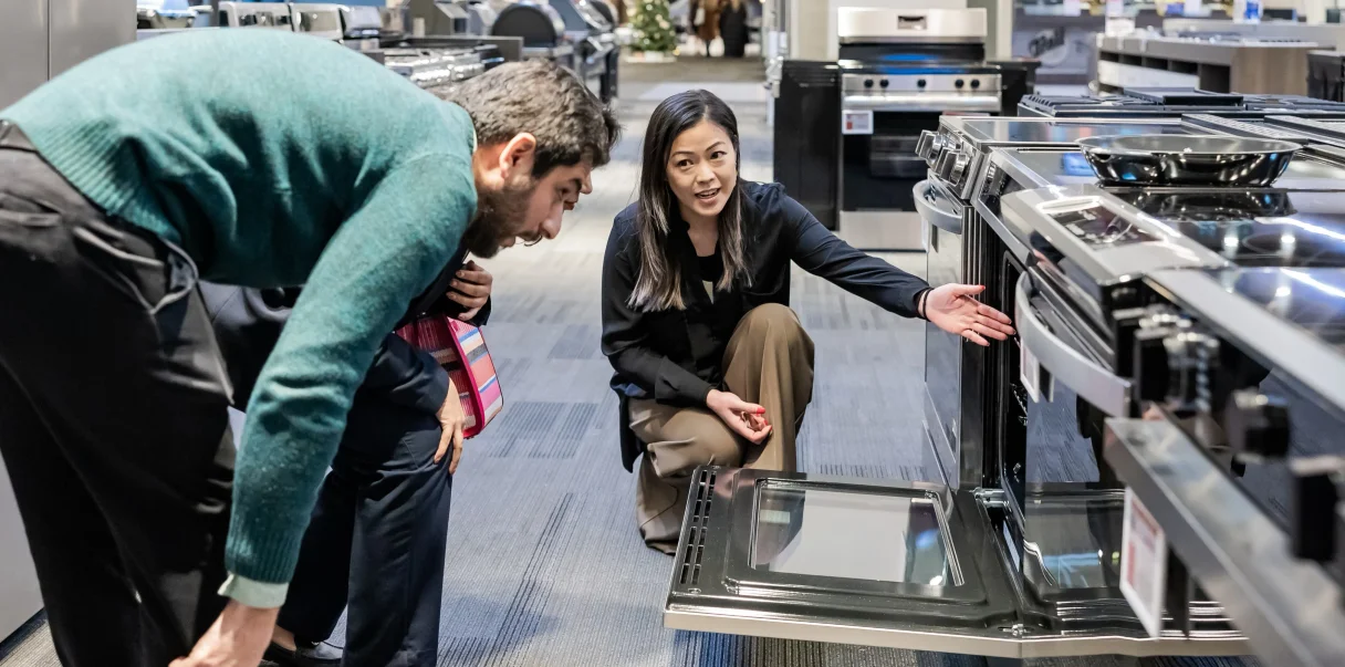 An appliances expert greeting customers in the Trail Appliances showroom