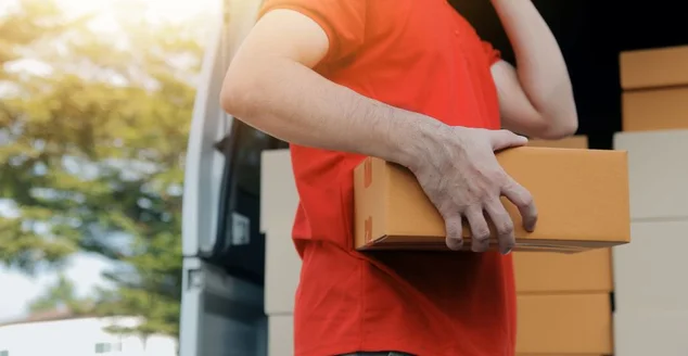 Entregador asiático, entregador expresso, jovem, usa caixas para cliente, ele usa máscara protetora na frente de casa