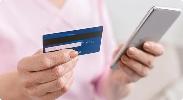 Mulher sênior, compras on-line com cartão de crédito e telefone