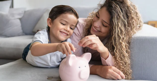 Mãe com o seu filho no colo cozinhando