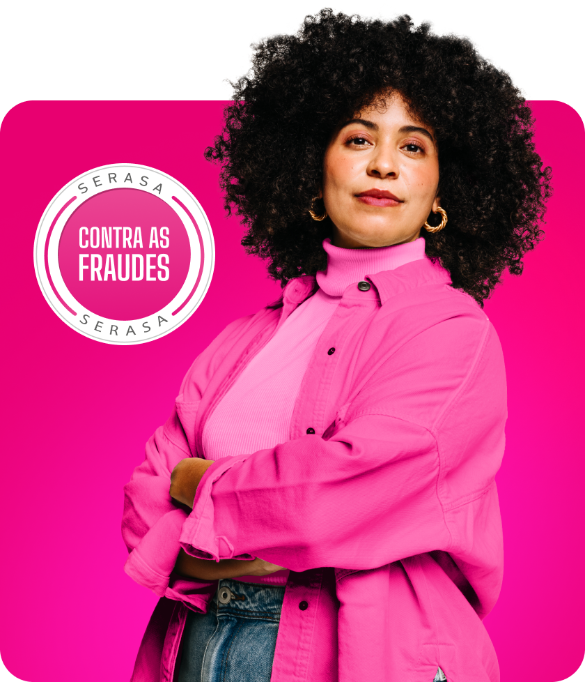 Mulher Branca com os braços cruzados. Vestindo uma roupa rosa e com os cabelos cacheados