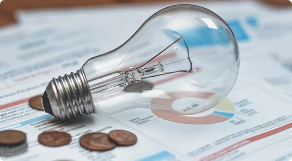 Contas de luz com lâmpada e moedas