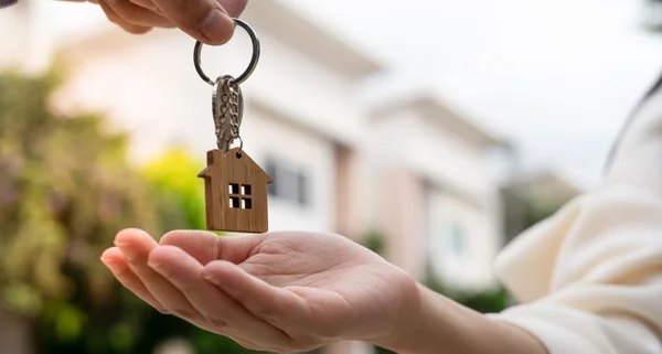 Os compradores de casas estão levando as chaves de casa dos vendedores. Contrato de negócio concluído. Venda sua casa, alugue casa e compre ideias.