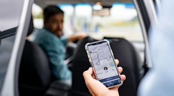 Man getting into a car he requested using a mobile app