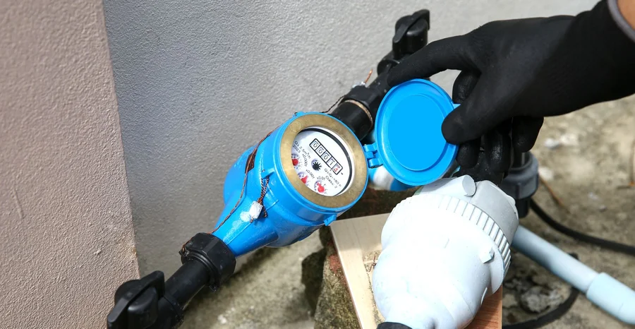 Técnico de encanador verifica a válvula do medidor de água da casa para pagamento de contas ou manutenção de serviço, conserta vazamento de queda do tanque de água da tubulação.