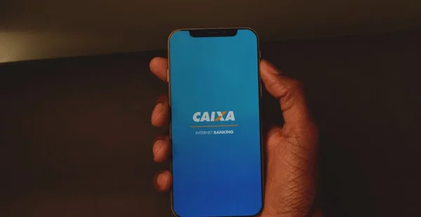 Smartphone em close com o aplicativo de internet banking da Caixa Econômica Federal, controle suas finanças com facilidade.