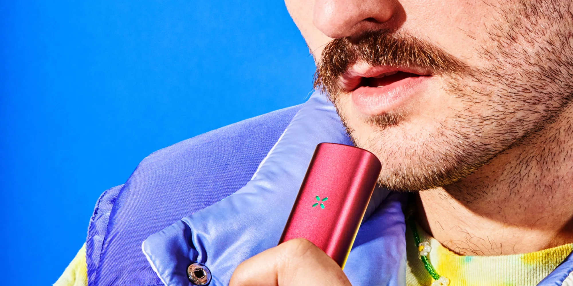 Guy with a mustache using the PAX dry herb and concentrate vaporizer