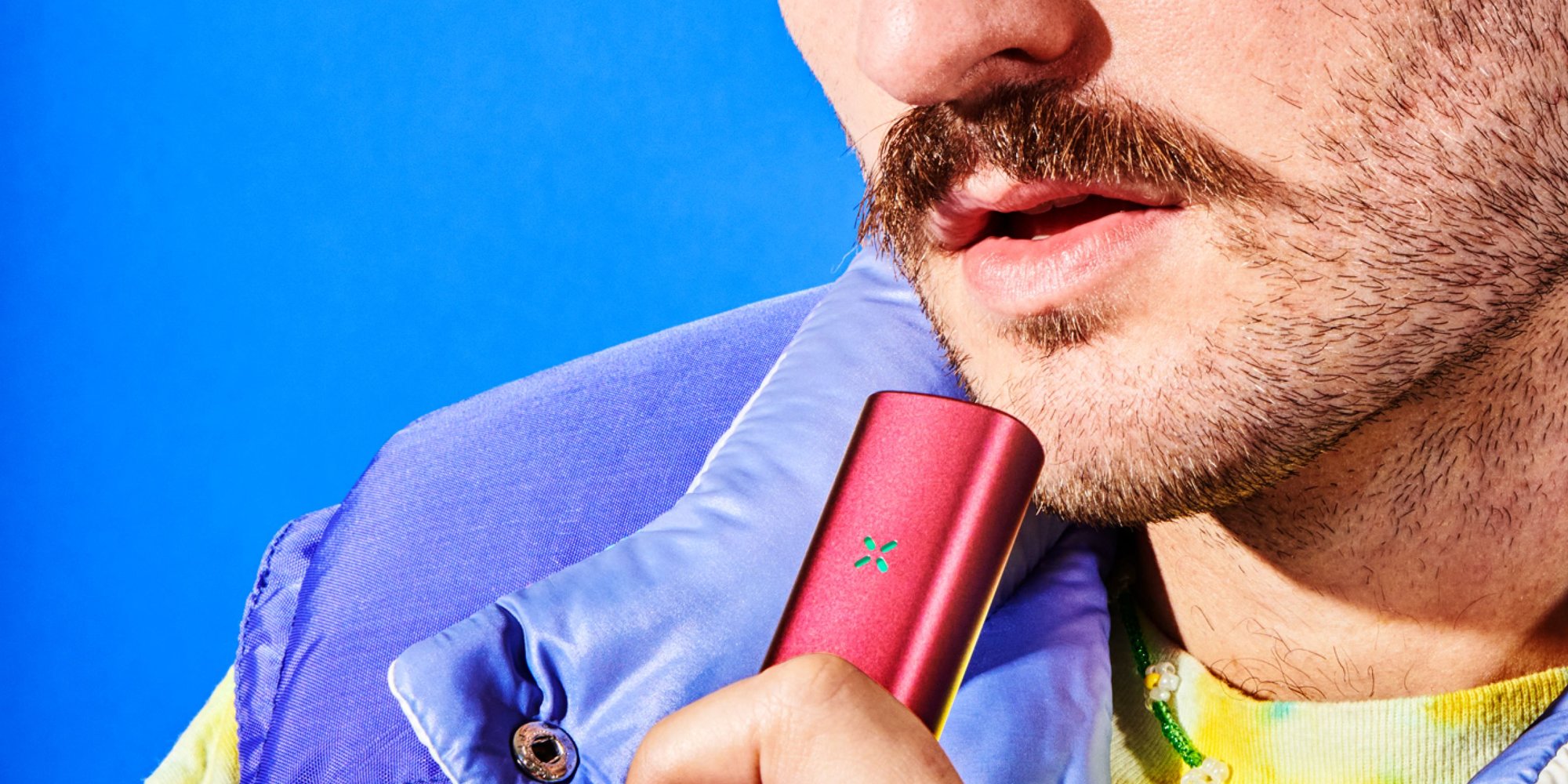 Guy with a mustache using the PAX dry herb and concentrate vaporizer