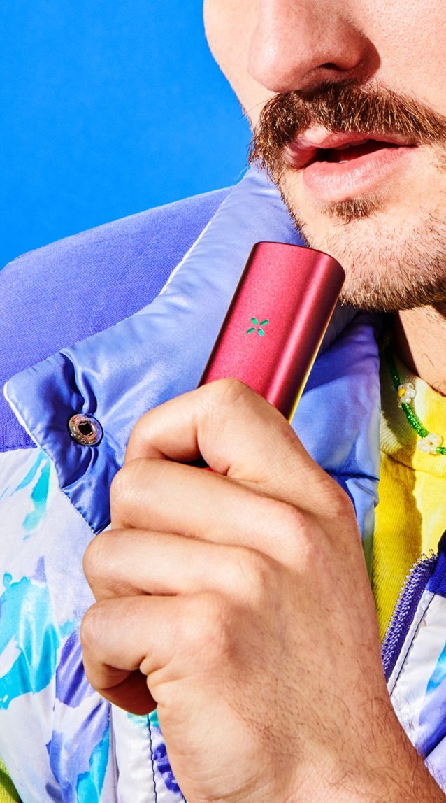 Guy with a mustache using the PAX dry herb and concentrate vaporizer