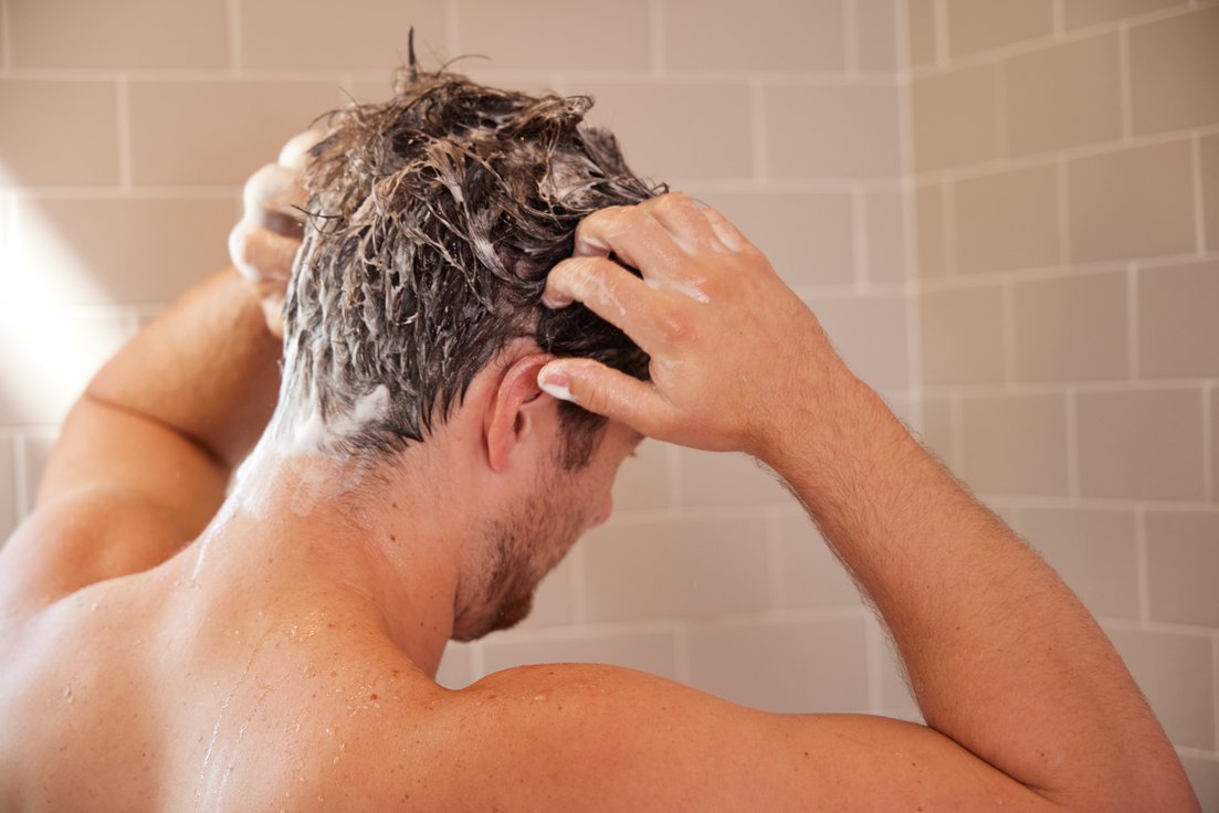 Man washing hair in the shower