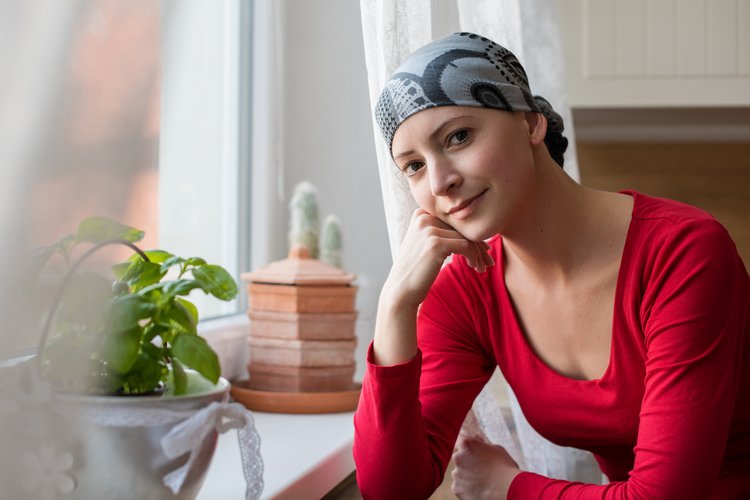 A woman wearing a bandana after experiencing hair loss from chemotherapy.