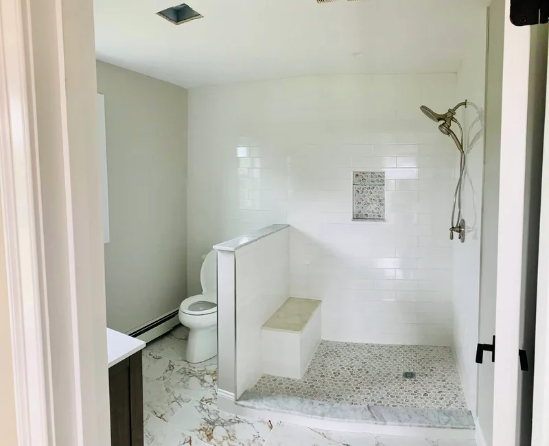 Finished addition bathroom with tiled walk-in shower and bench