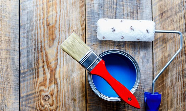 Blue paint can, brush, and roller