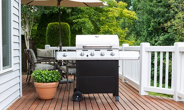 Large barbecue cooker on cedar deck