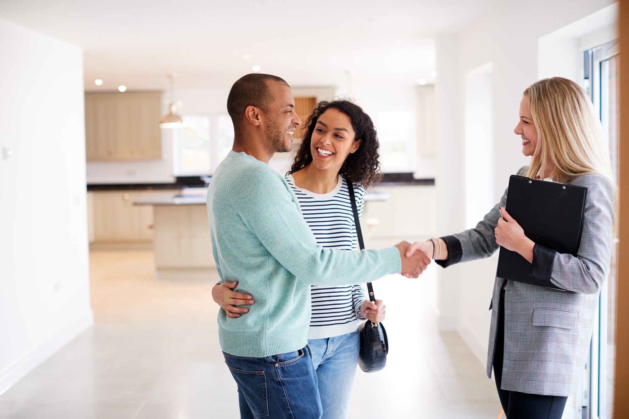 Homebuyer couple making a deal with a realtor