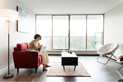 Woman working in her modern condominium apartment home