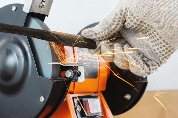 Blade being sharpened on a grinder
