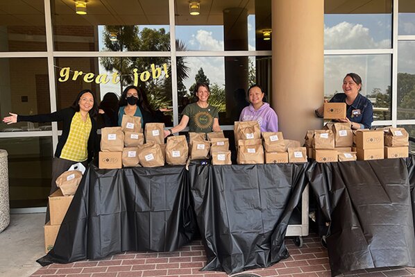 CSULB BUILD team members setting up lunches for AIM Program participants.