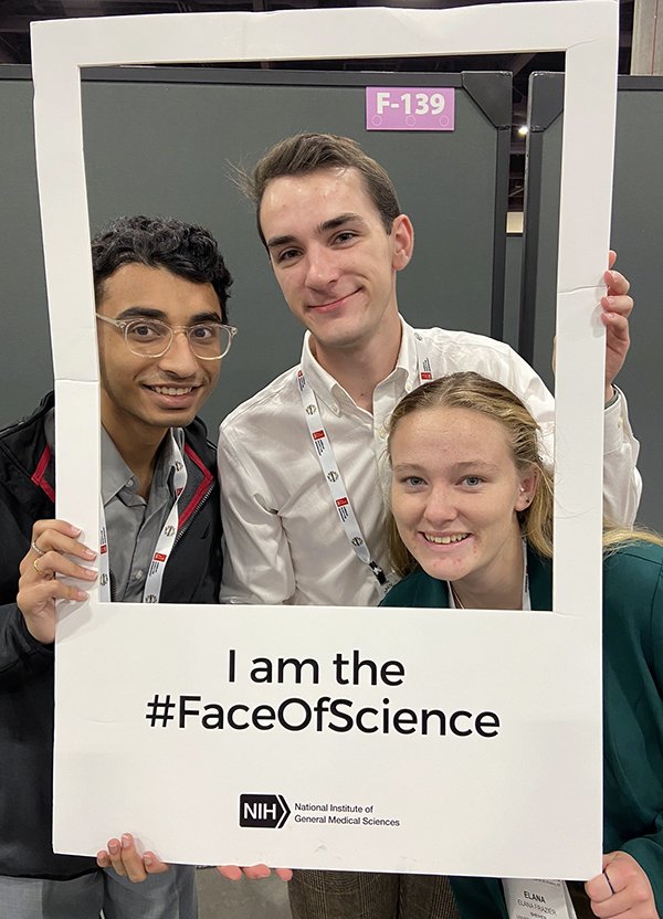 Andrew Ocinar (center) with two other UMBC STEM BUILD trainees at ABRCMS 2023. 
