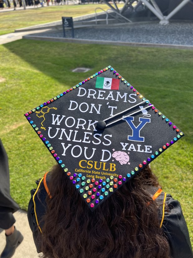 Top of Tyler Nelson’s graduation cap decorated with “Dreams Don’t Work Unless you Do” CSULB California State University Long Beach