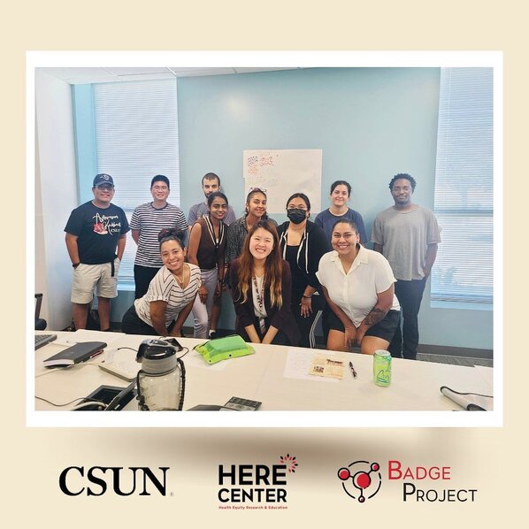 HERE Center Operations Manager Amber Bui (front center) with Badge Project Coordinator Elizabeth Gutierrez (front right) at an information session in 2023. 