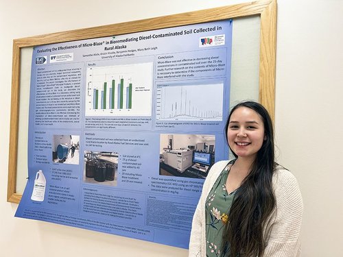 Samantha Wade stands in front of her research poster