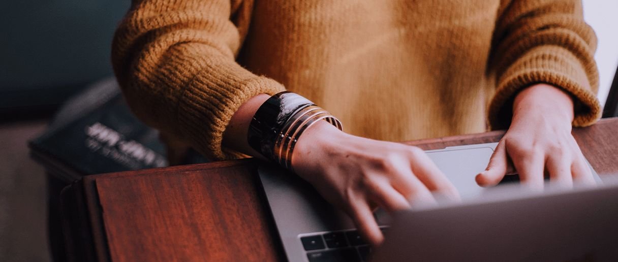 Person trading on laptop