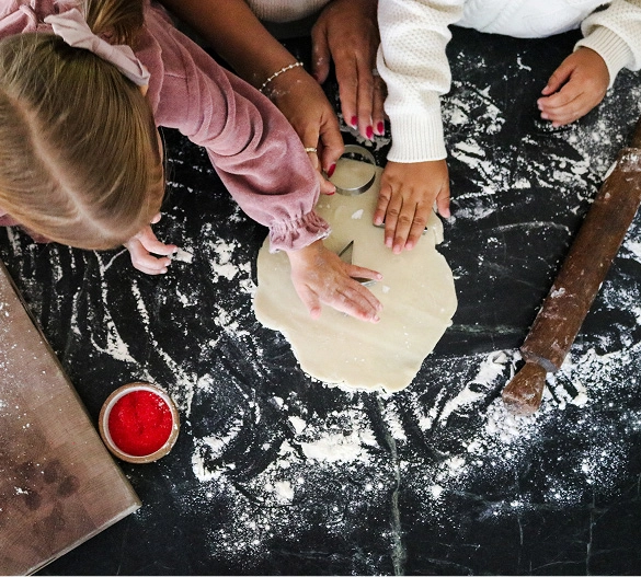Truly Free Laundry Wash and refill pouch in a laundry room, with a woman and baby in the background.