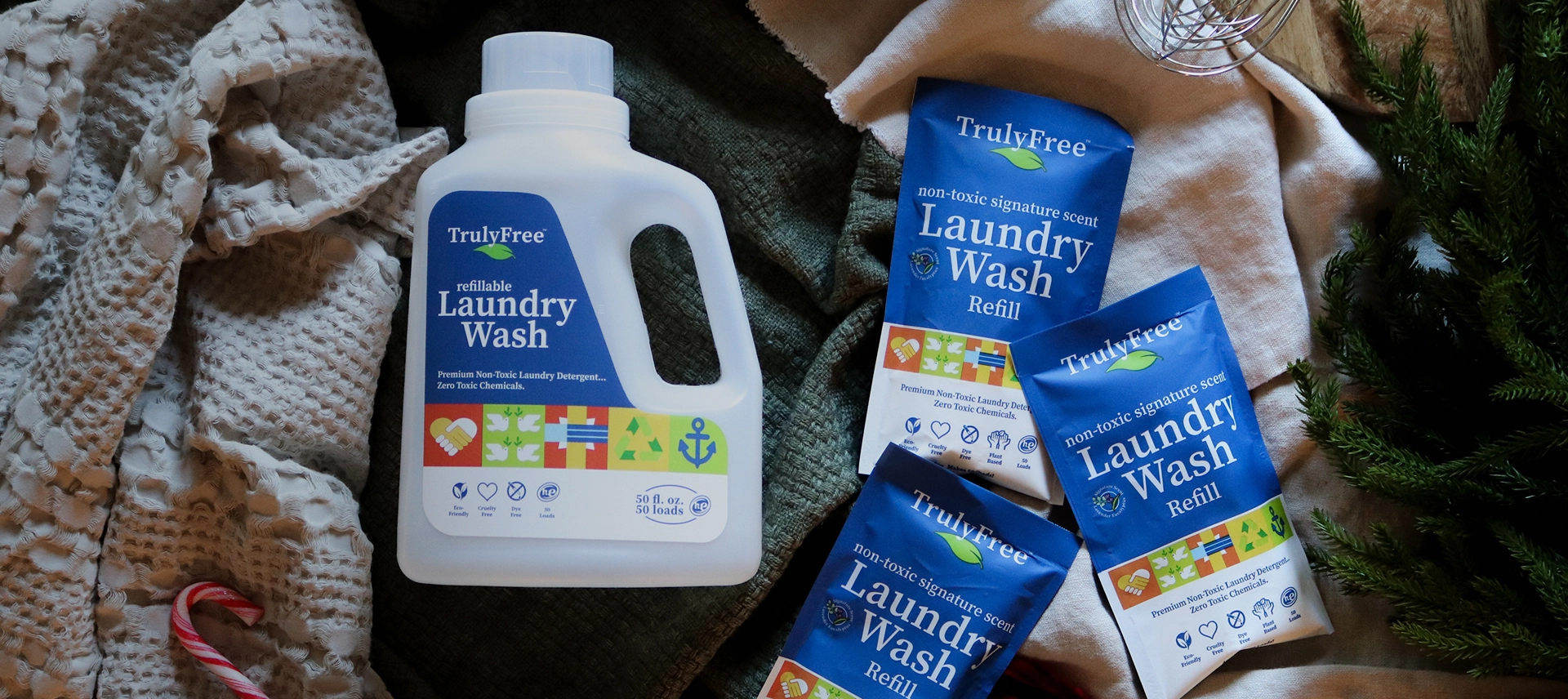 Truly Free Laundry Wash and refill pouch in a laundry room, with a woman and baby in the background.
