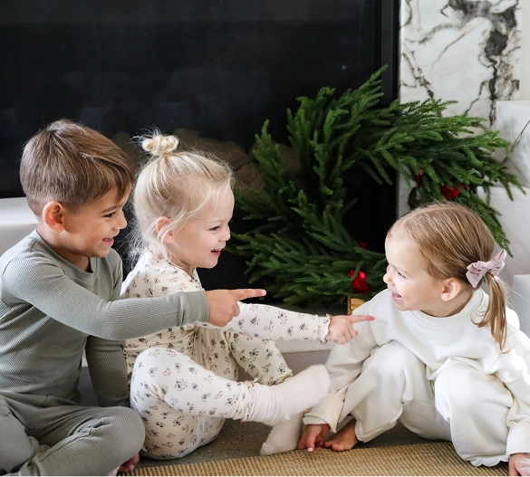 Truly Free Laundry Wash and refill pouch in a laundry room, with a woman and baby in the background.