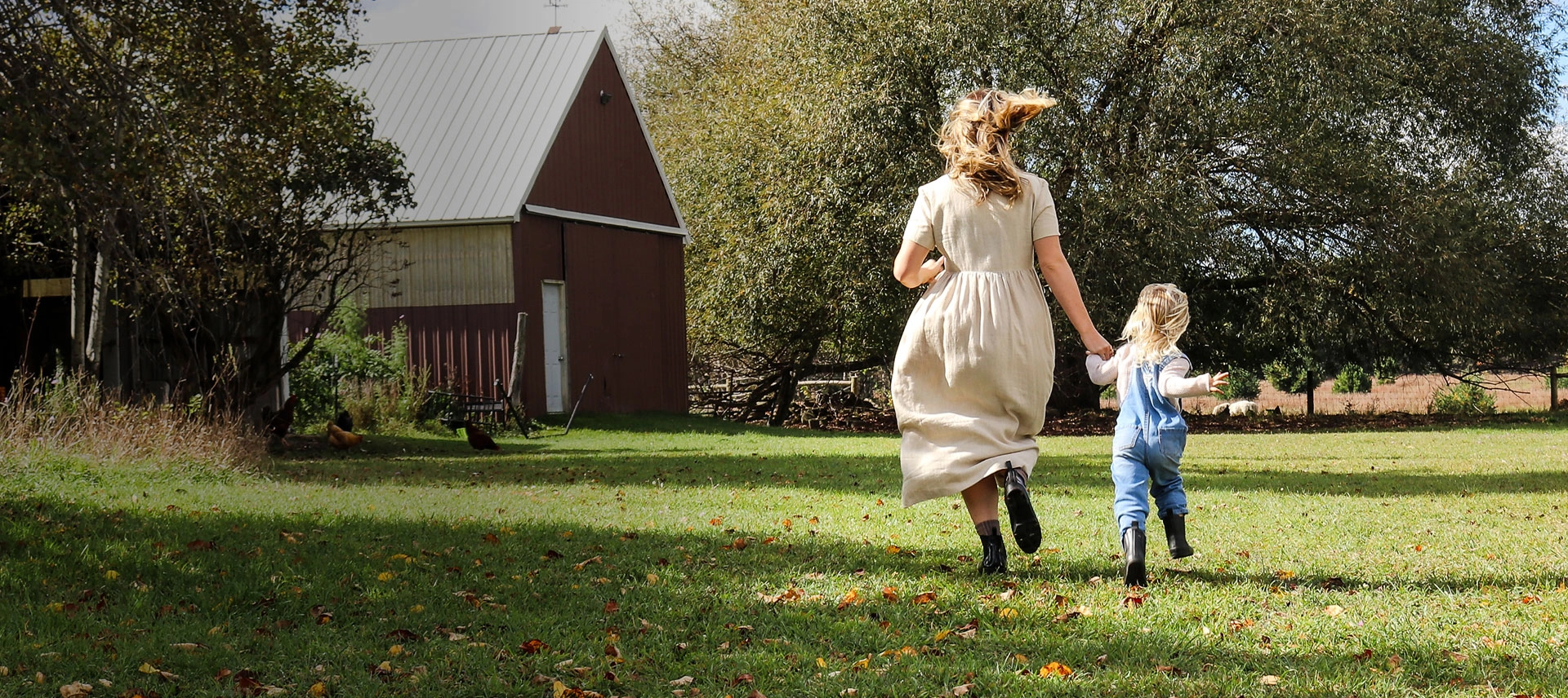 Truly Free Laundry Wash and refill pouch in a laundry room, with a woman and baby in the background.